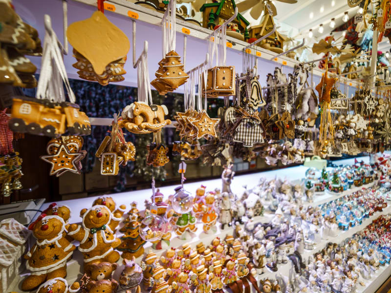 Close‑up of a Christmas market stall filled with hanging gingerbread ornaments and festive figurines