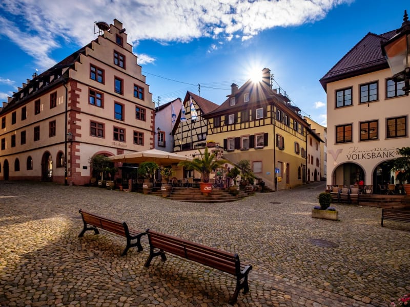 Cobbled square in Endingen with historic façades and café terrace at sunset