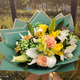 Carnival Mixed Flower Bouquet of of white lilies with Pink carnation, yellow Roses, baby’s breath and alstromeria 