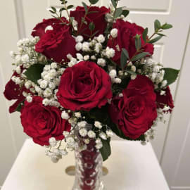 Red Roses with baby's breath  and Eucalyptus filling in a crystal vase 