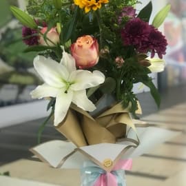 Bouquet of Sunflower, lily, solidago, chrysanthemum, pink rose and rose chapeau.