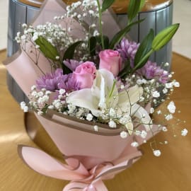 Elegant arrangement of white lilies, pink roses, and chrysanthemums in the Enchanting Elegance Bouquet