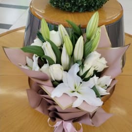 Blissful white roses and lilies bouquet.