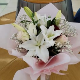 Symbolic bouquet: love, admiration, purity, innocence in a glass vase for a special birthday gift.