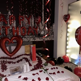 Playful birthday room with a themed backdrop and a dessert table filled with treats