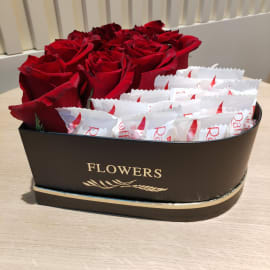 Heart-shaped box filled with red roses and Raffaello chocolates