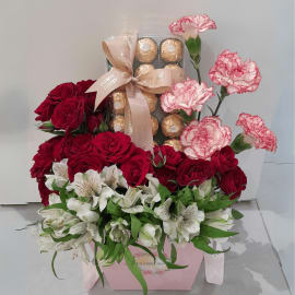  Gift box overflowing with love, friendship, and sweet indulgence - red roses, alstroemeria, carnations, and chocolates.