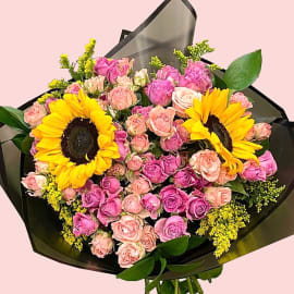 Bouquet of Sunflowers, dark light pink roses, solidago and eucalyptus in black wrapping. 