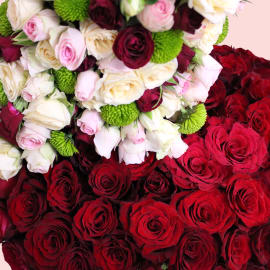 Close-up of a lavish flower display with many red roses.
