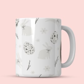 Easter-themed mug featuring cute bunnies and flowers.