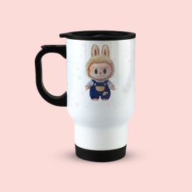 White travel mug with a black handle and lid, showcasing a full-body illustration of the Labubu character on a light pink background.