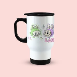 A white travel mug with a black handle and lid, featuring a colorful illustration of a green monster character and a purple monster character, along with the partial word 