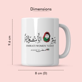 A white ceramic mug showcasing the dimensions (9.6 cm height, 8 cm diameter) and an Arabic calligraphy design for Emirati Women's Day.