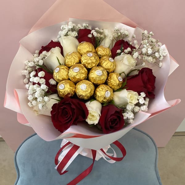 Red And White Roses Bouquet with Ferrero Rocher topping and baby's breath filling.