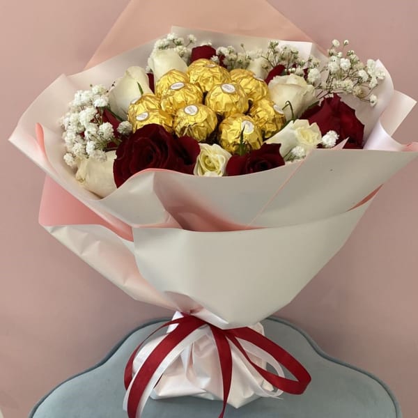 Red And White Roses Bouquet with Ferrero Rocher topping and baby's breath filling.