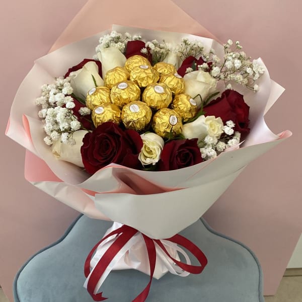 Red And White Roses Bouquet with Ferrero Rocher topping and baby's breath filling.