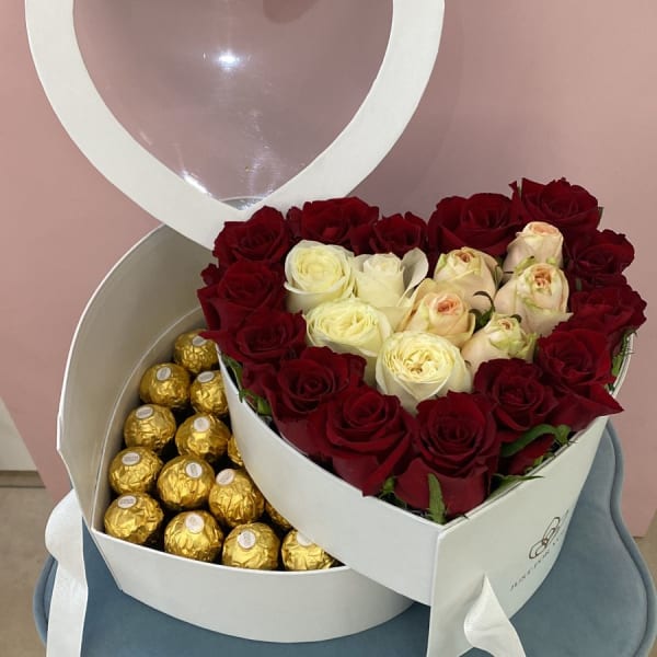 Arrangement of white and red roses with a Ferrero Rocher chocolates in a two-tier white Heart Box.