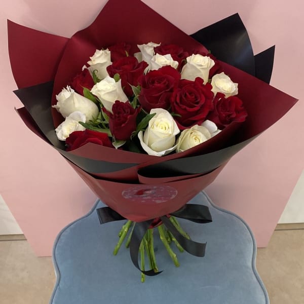 Red and White Roses bouquet wrapped in an elegant red Sheet.