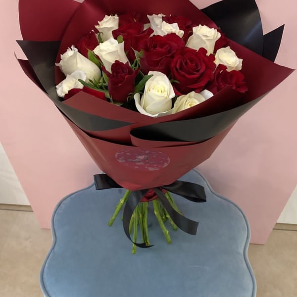 Red and White Roses bouquet wrapped in an elegant red Sheet.