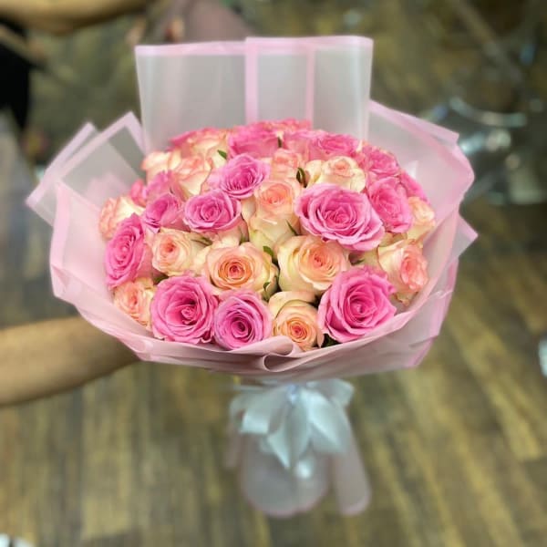 Bouquet of White and Pink Roses in an elegant white wrapping. 