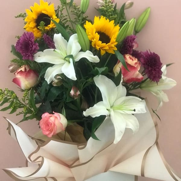 bouquet of sunflowers, lily, pink rose, solidago, alstroemeria, chrysanthemum, and rose chapeau.