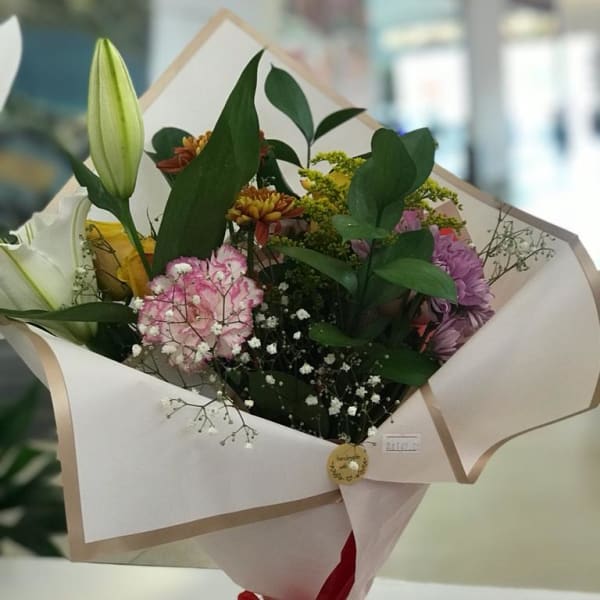 Bouquet of Carnation, lily, solidago, chrysanthemum, yellow rose gypsophila and ruscus 