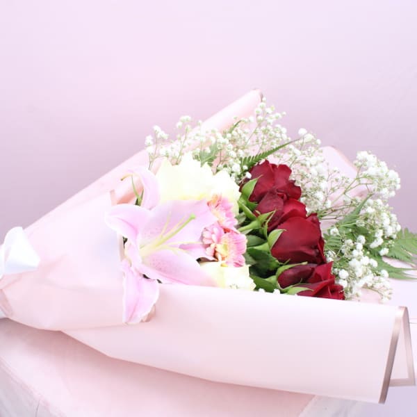 Mixed Flower Bouquet containing red roses, with Gypsophila decoration along with pink Lilly, Gerbera and fern 