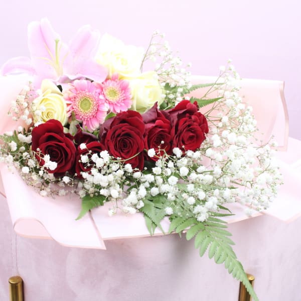 Mixed Flower Bouquet containing red roses, with Gypsophila decoration along with pink Lilly, Gerbera and fern