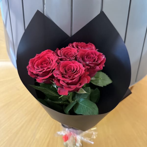 Elegant Ruby Romance Bouquet featuring 5 vibrant red roses wrapped in a sleek black sheet