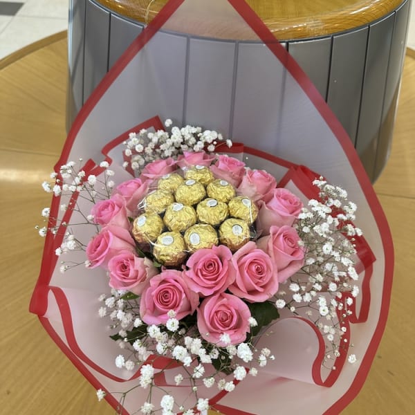 Close-up of Elegant Affection Bouquet featuring vibrant pink roses and Ferrero Rocher chocolates