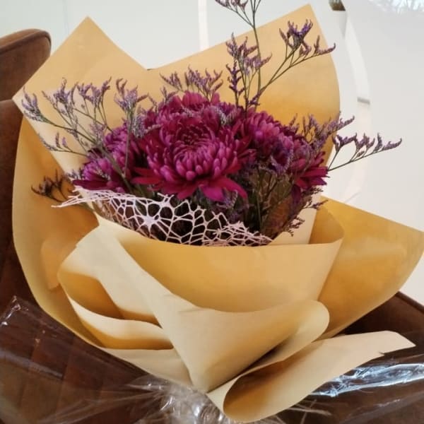 Rich purple floral arrangement symbolizing regal beauty and mystery.