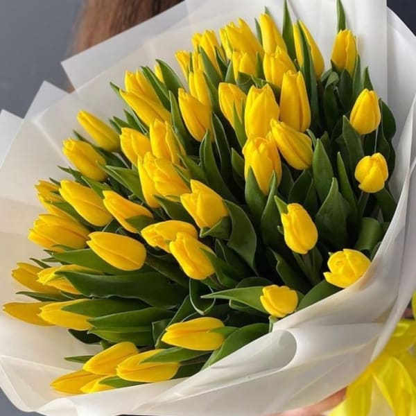 Image of a bouquet featuring 45 vibrant yellow tulips, symbolizing abundance, joy, and happiness, perfect for gifting and brightening someone's day