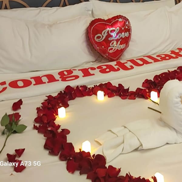 Heart-shaped helium balloons suspended from the ceiling, adding a romantic flair.