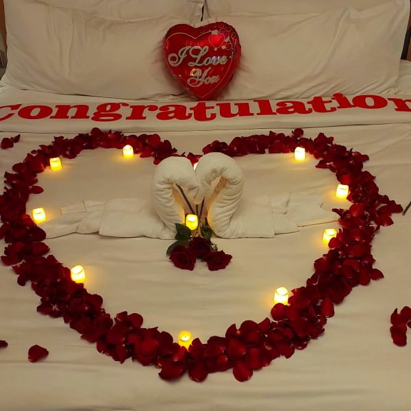 The floor covered with rose petals and balloons, inviting a dance of love.