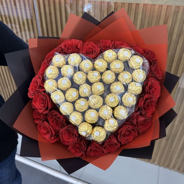 Stunning arrangement of 21 roses and 35 Ferrero Rocher chocolates in a heart shape.