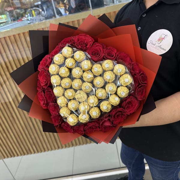  Romantic heart-shaped bouquet of roses and Ferrero Rocher chocolates.