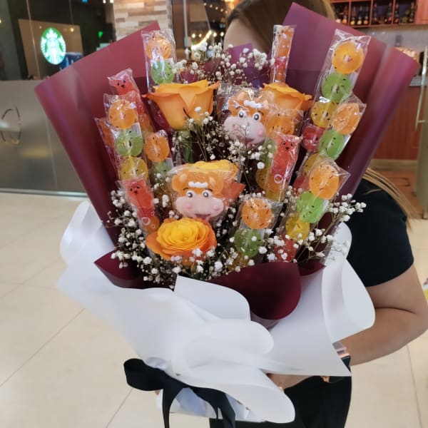 Fresh orange roses and baby's breath in a Halloween bouquet