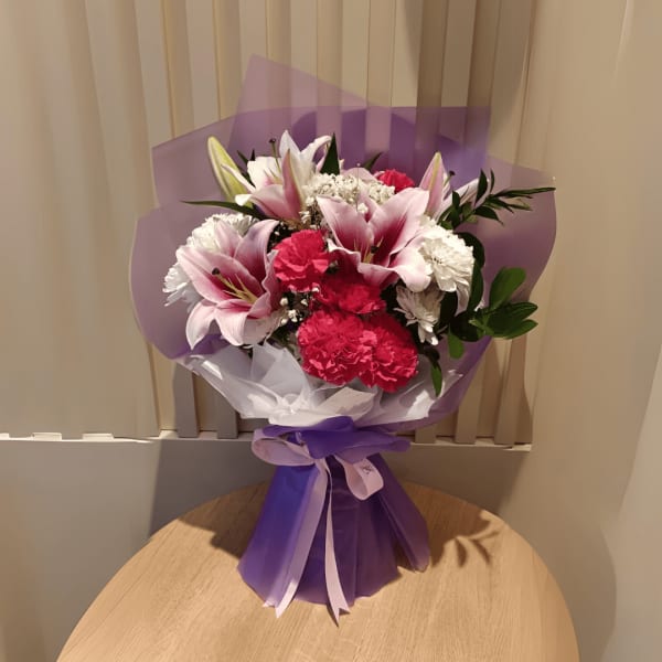 Soft and graceful, this bouquet of pink lilies and baby's breath exudes innocent elegance
