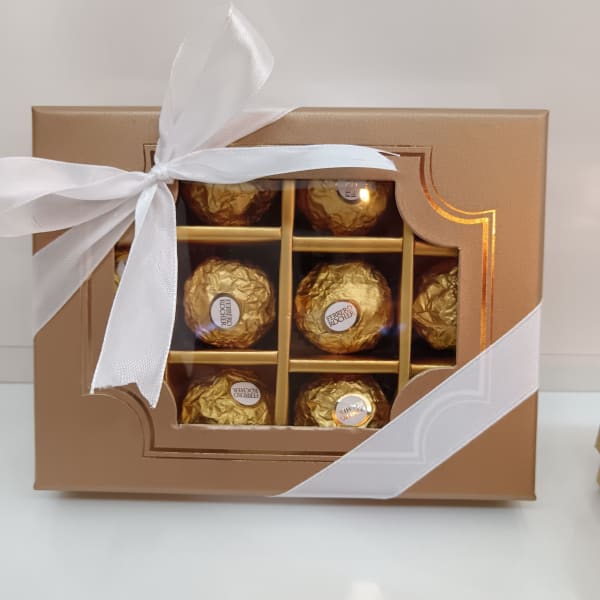 Light brown gift box containing 12 golden Ferrero Rocher chocolates.