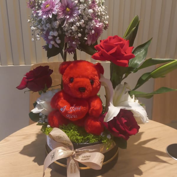 It contains 1 white Lilie , 1 purple chrysanthemum, 3 red roses, 2 white roses, 4 leaves ruscus, and 2 Gypsophila (Baby Breath)