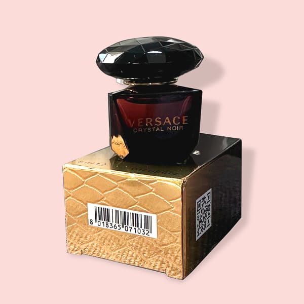 A glass bottle of unisex perfume with warm amber and sandalwood notes side view
