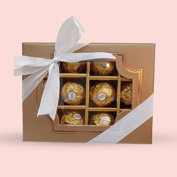 Light brown gift box containing 12 golden Ferrero Rocher chocolates.
