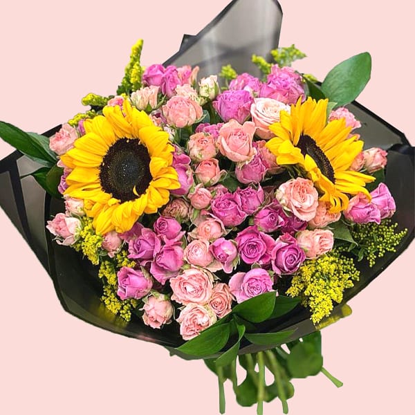 Bouquet of Sunflowers, dark light pink roses, solidago and eucalyptus in black wrapping. 
