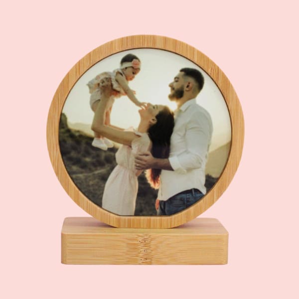 Clear round acrylic photo frame with a personalized photo display.