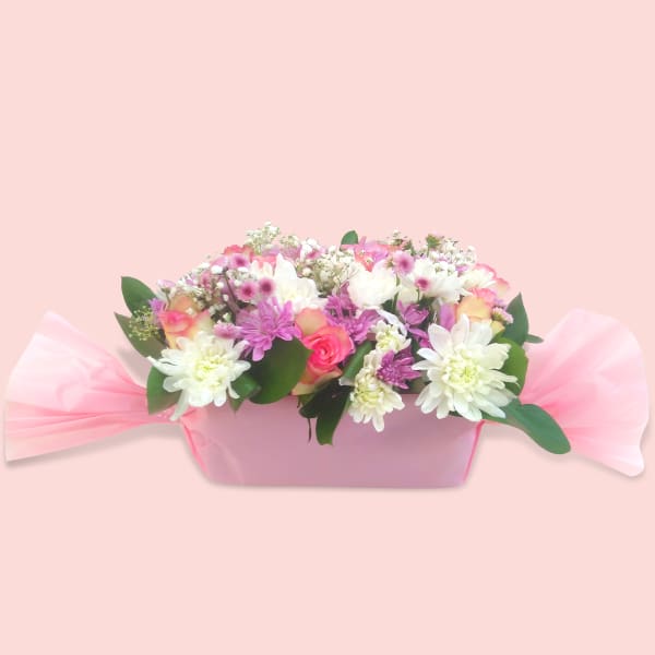 legant pink and white floral arrangement with roses and chrysanthemums.