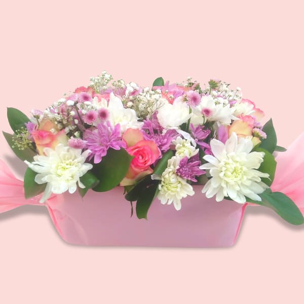 Beautiful flower bouquet featuring pink roses, white chrysanthemums, and baby’s breath.