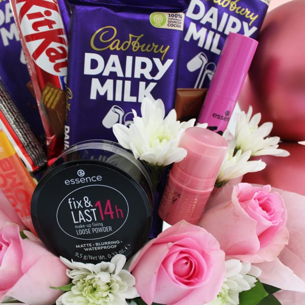 Close-up of Dairy Milk and KitKat chocolates in floral gift mug