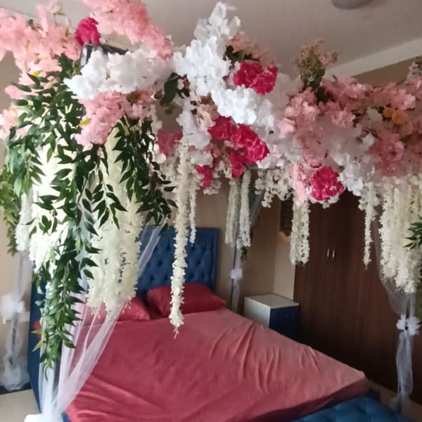 Wedding room decoration with flowers and tulle.