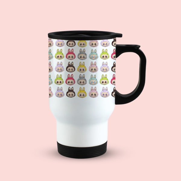 A single white travel mug with a black handle and lid, showcasing a repeating pattern of colorful cartoon bunny faces, viewed from the front-right.