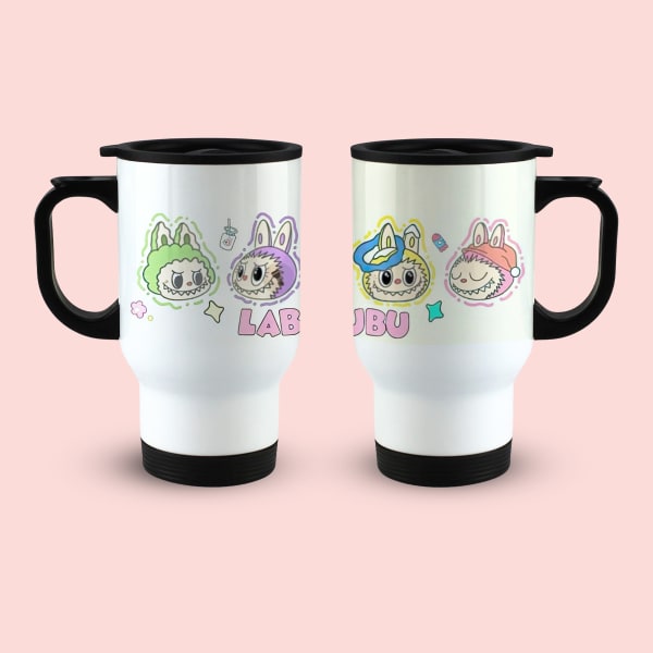 wo identical white travel mugs with black handles and lids, displayed side-by-side. The left mug shows a green and purple monster character with the word 